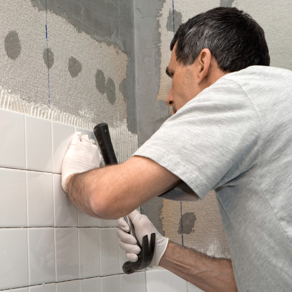 Skills At Work - Man Tiling Shower
